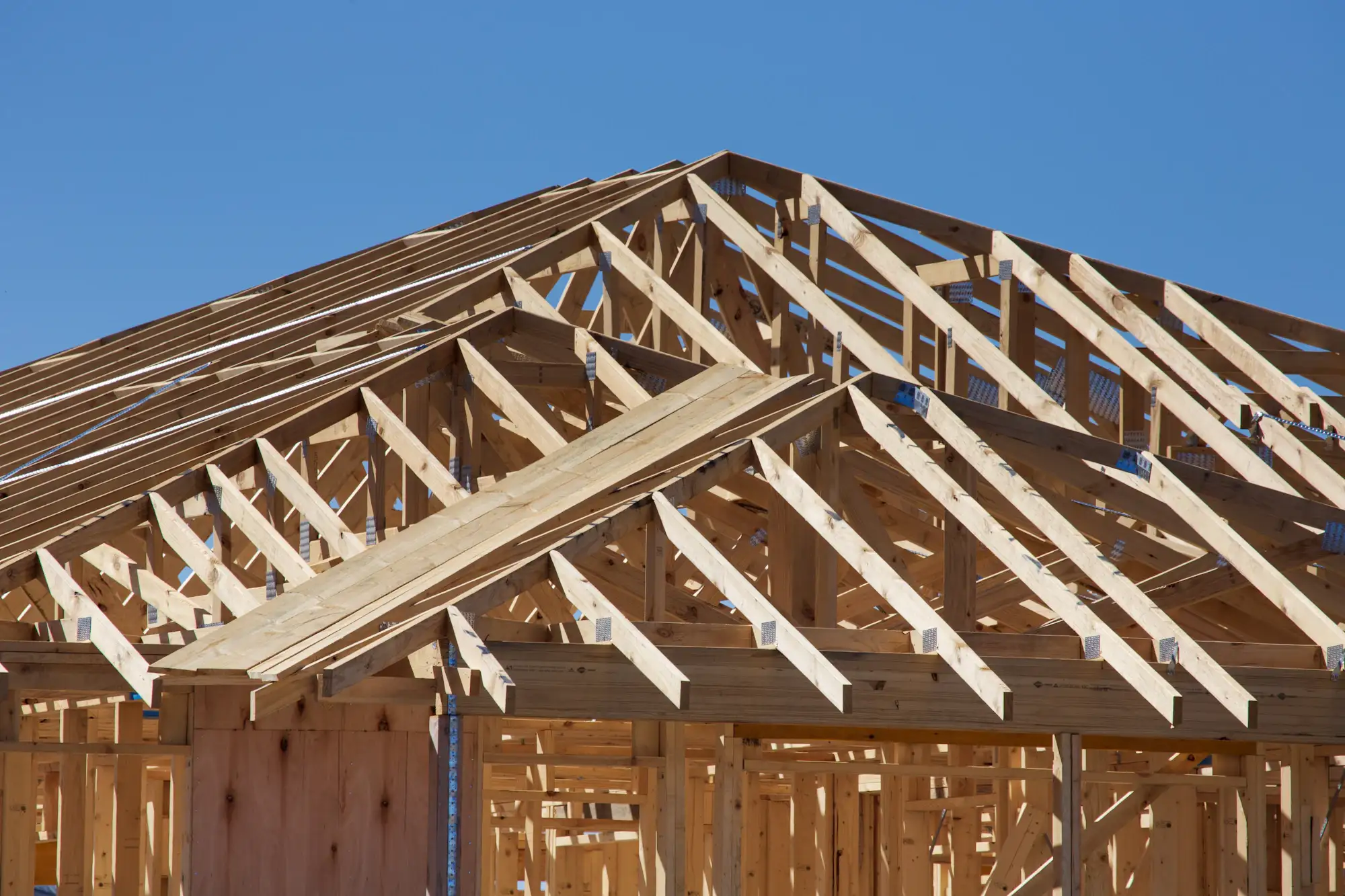 A house under construction with its roof framing exposed