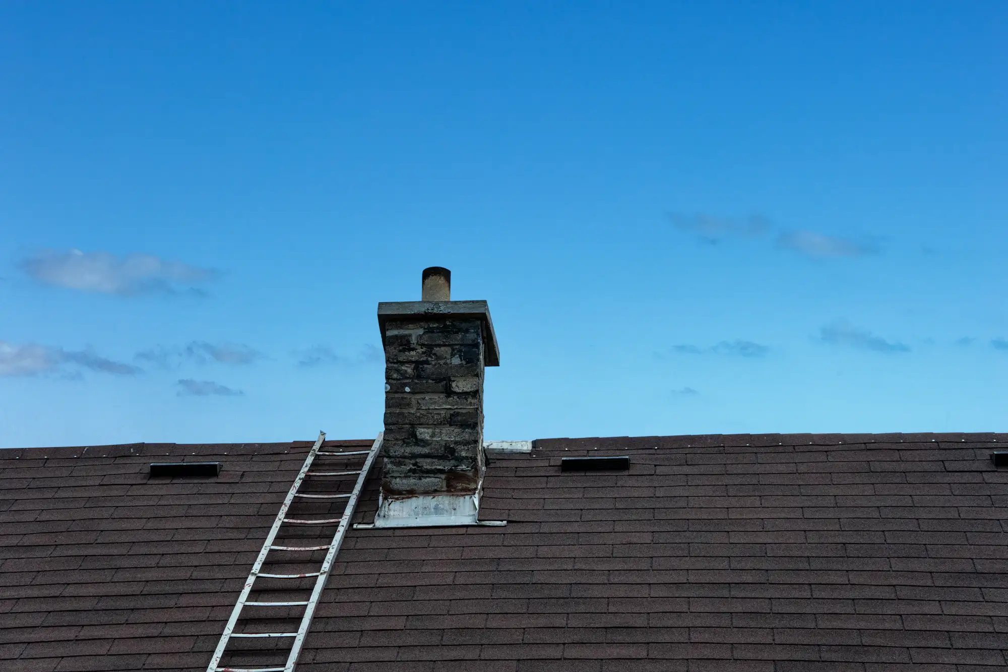 A ladder against the roof of a house