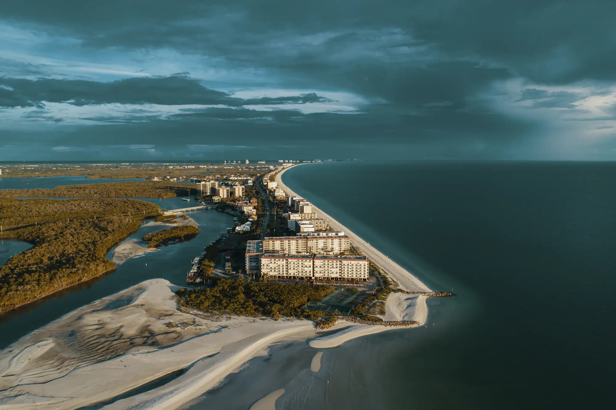 A house beside the Gulf in Bonita Springs under grey clouds