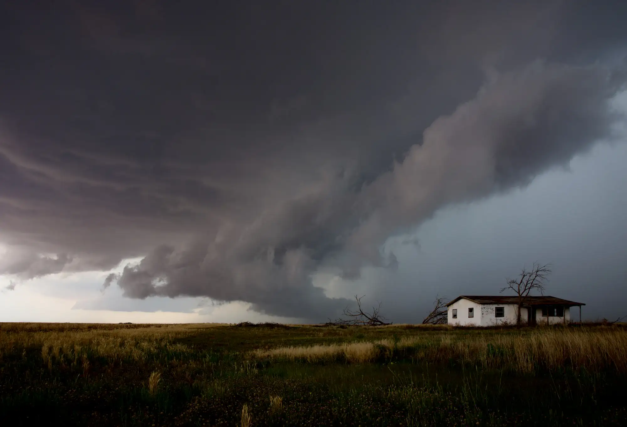 Storm clouds and rain closing in on a house